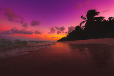 Scenic view of sea against romantic sky at sunset