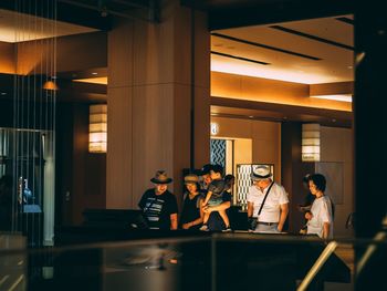 People sitting in illuminated room