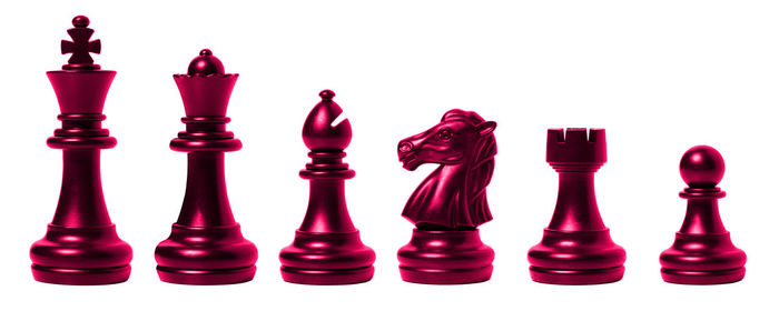 Close-up of chess pieces against colored background