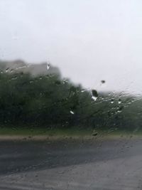 Close-up of wet glass window in rainy season