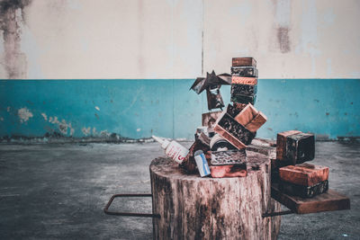 Close-up of rusty metal on table against wall