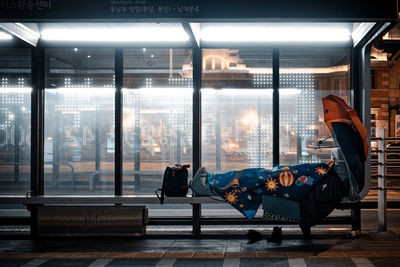 Man sitting on chair in illuminated room