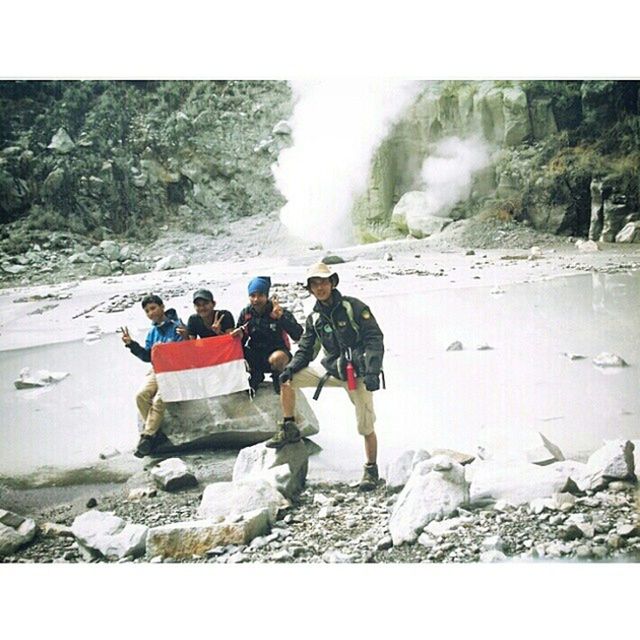 lifestyles, men, leisure activity, rock - object, large group of people, water, person, rock formation, tourist, waterfall, tourism, vacations, travel, motion, full length, medium group of people, mountain, rear view, nature