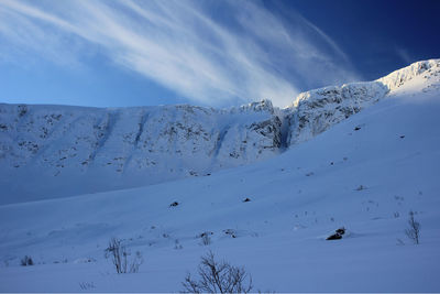 Scenic view of snow covered mountains against sky