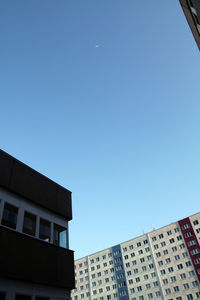 Low angle view of buildings against clear blue sky