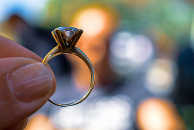 Close-up of hand holding ring