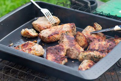 High angle view of meat on barbecue grill