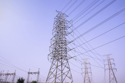 Low angle view of electricity pylon against clear sky