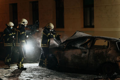 People standing in abandoned car