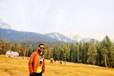 Full length of man standing on land against sky