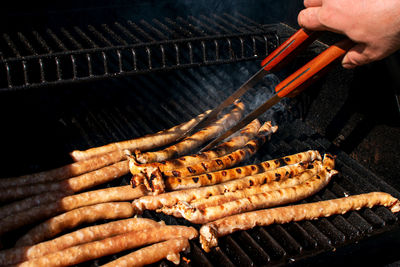 Man preparing food on barbecue grill