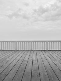 Surface level of pier on sea against sky