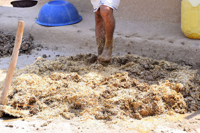 Low section of man working on sand