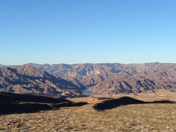 Scenic view of mountains against clear blue sky