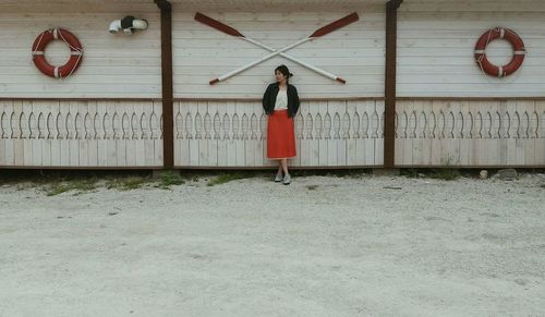 Woman standing against wall