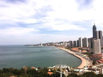 View of cityscape against cloudy sky