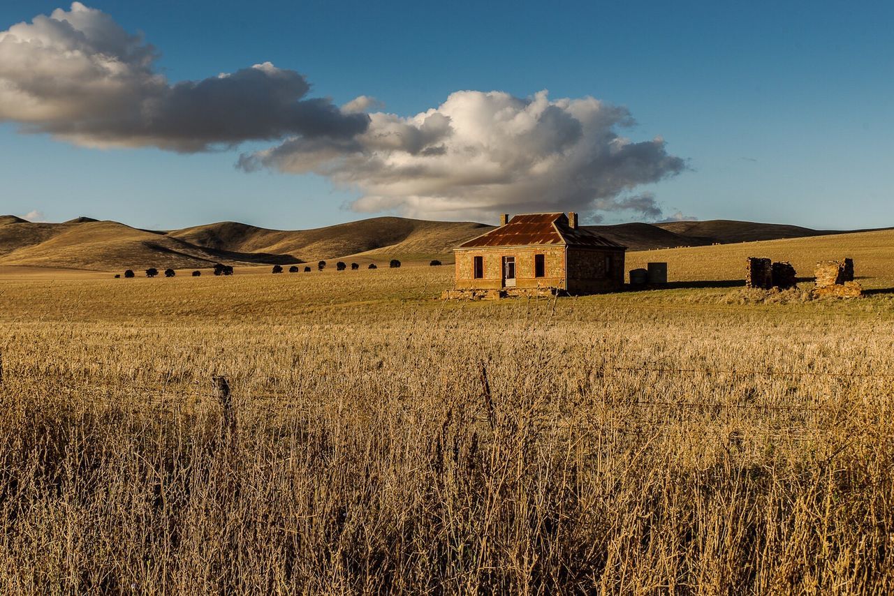 field, sky, cloud - sky, landscape, built structure, nature, architecture, tranquility, no people, day, rural scene, tranquil scene, building exterior, outdoors, beauty in nature, grass, scenics