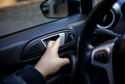 Midsection of man using laptop in car