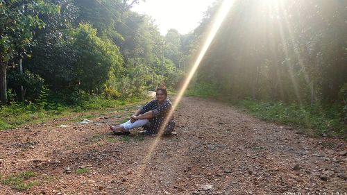 Man climbing on land in forest