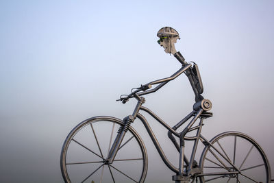 Metal man with giant bicycle. sport and active life concept