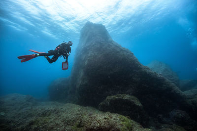 Woman scuba diving undersea
