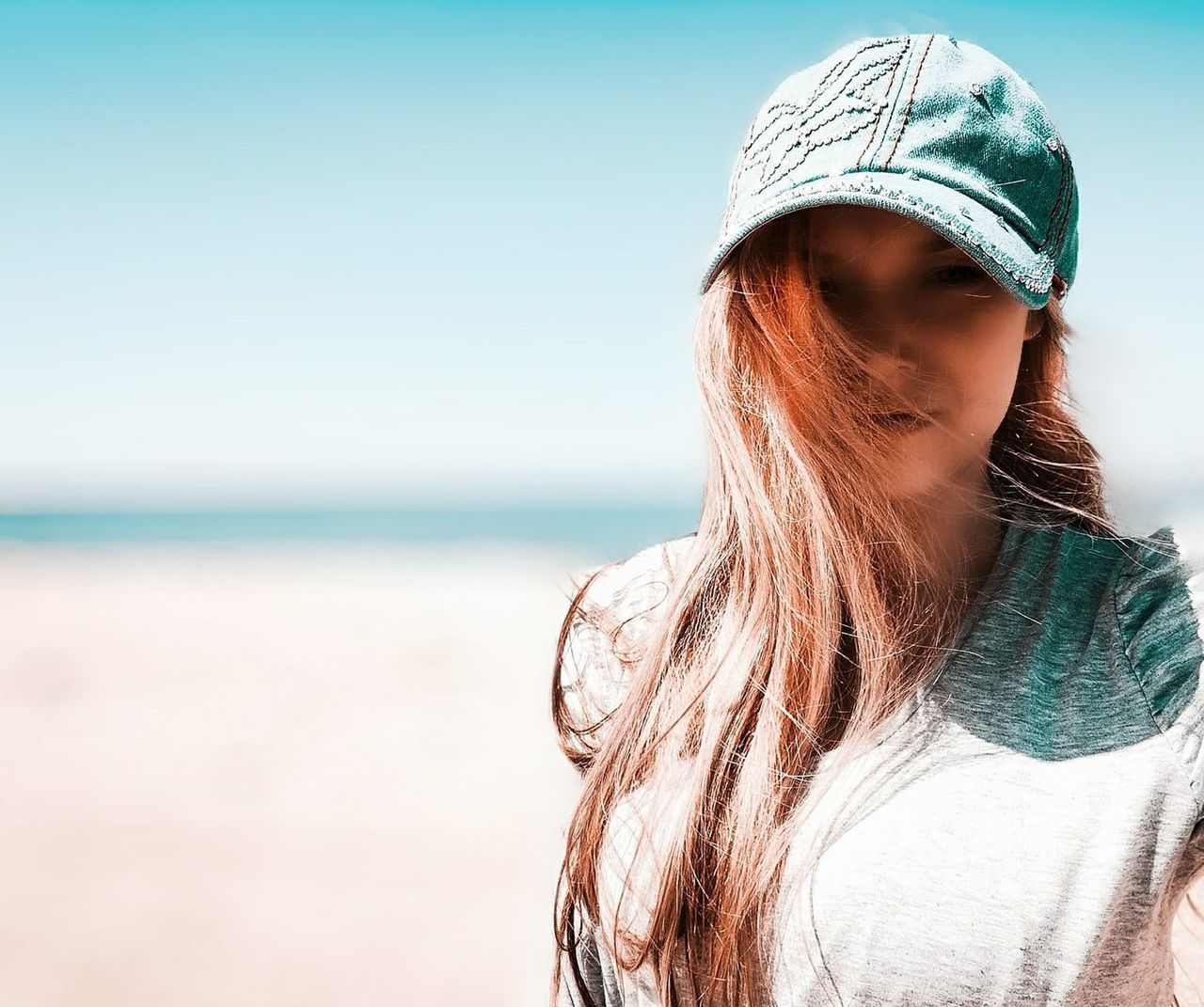 one person, sea, water, adult, beach, land, women, long hair, sky, hairstyle, nature, young adult, portrait, blue, clothing, horizon over water, headshot, vacation, hat, trip, holiday, copy space, horizon, leisure activity, photo shoot, day, summer, lifestyles, looking, relaxation, fashion accessory, sunlight, casual clothing, outdoors, brown hair, clear sky, fashion, rear view, female, cap, spring, beauty in nature, person, human hair, focus on foreground, travel, standing, sand, tranquility, travel destinations, waist up, portrait photography, sunny