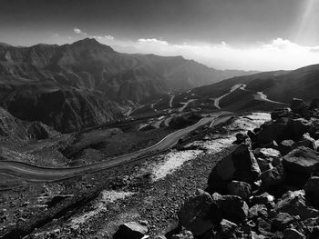 Scenic view of mountains against cloudy sky