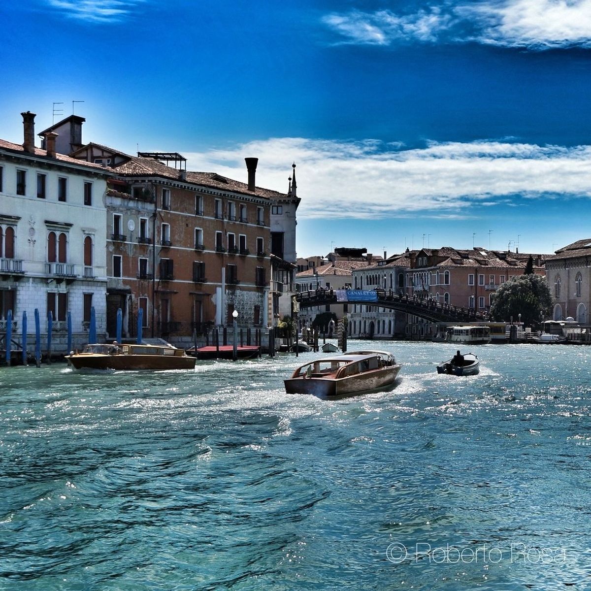 building exterior, architecture, built structure, water, waterfront, nautical vessel, sky, city, transportation, mode of transport, boat, blue, residential building, residential structure, moored, canal, building, river, sea, rippled