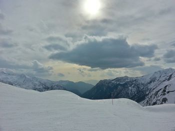 Scenic view of snow covered mountains against sky