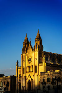 Low angle view of church against blue sky