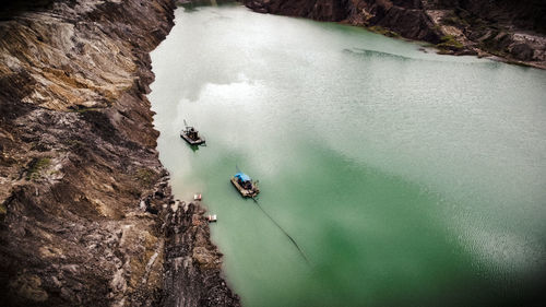 High angle view of people on rock by sea