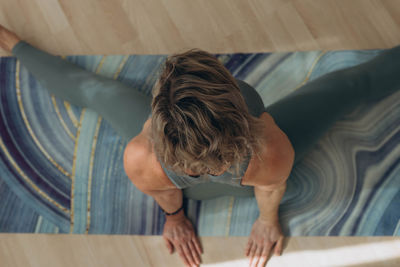 High angle view of woman sitting on floor