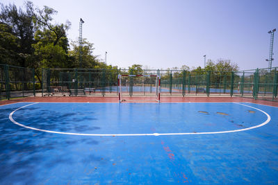 Scenic view of basketball hoop against blue sky