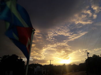 Low angle view of flag against sky during sunset