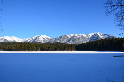 Scenic view of snowcapped mountains against blue sky