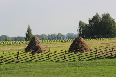 Hay bales on field against sky