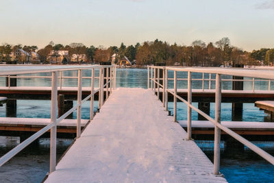 Footbridge over pier against sky