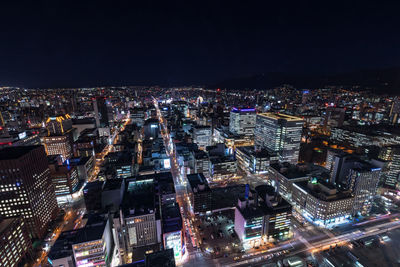 High angle view of illuminated city buildings at night