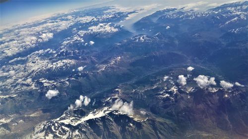 Aerial view of sea and mountains against sky