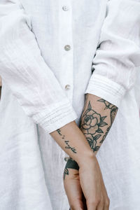 Midsection of woman standing by wall