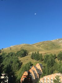 High angle view of mountains against clear blue sky