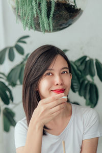 Portrait of a smiling young woman at home