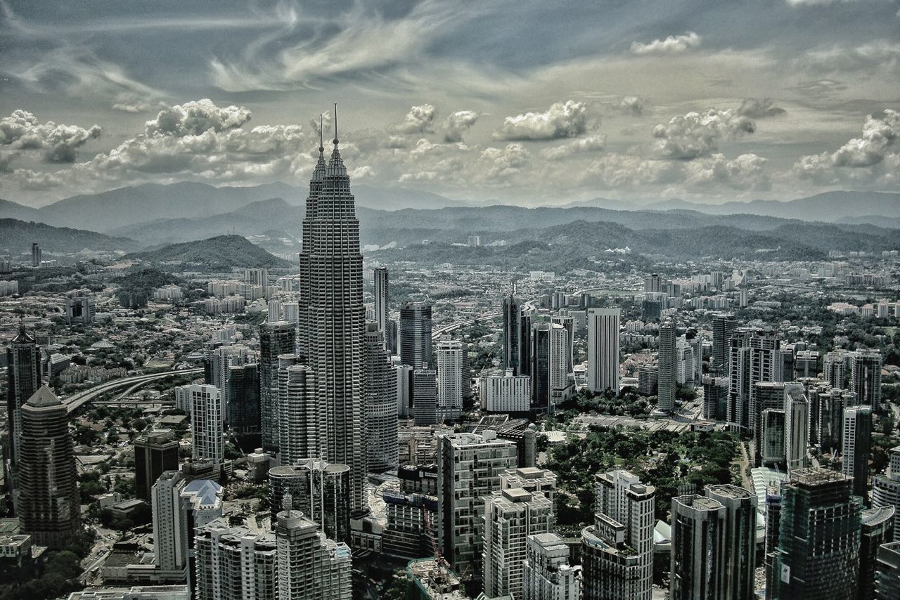 city, building exterior, architecture, cityscape, skyscraper, built structure, tall - high, tower, crowded, sky, modern, office building, capital cities, high angle view, financial district, travel destinations, city life, cloud - sky, urban skyline, famous place