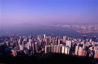 High angle view of city and sea against clear sky