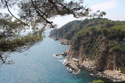 Scenic view of sea and mountains against sky