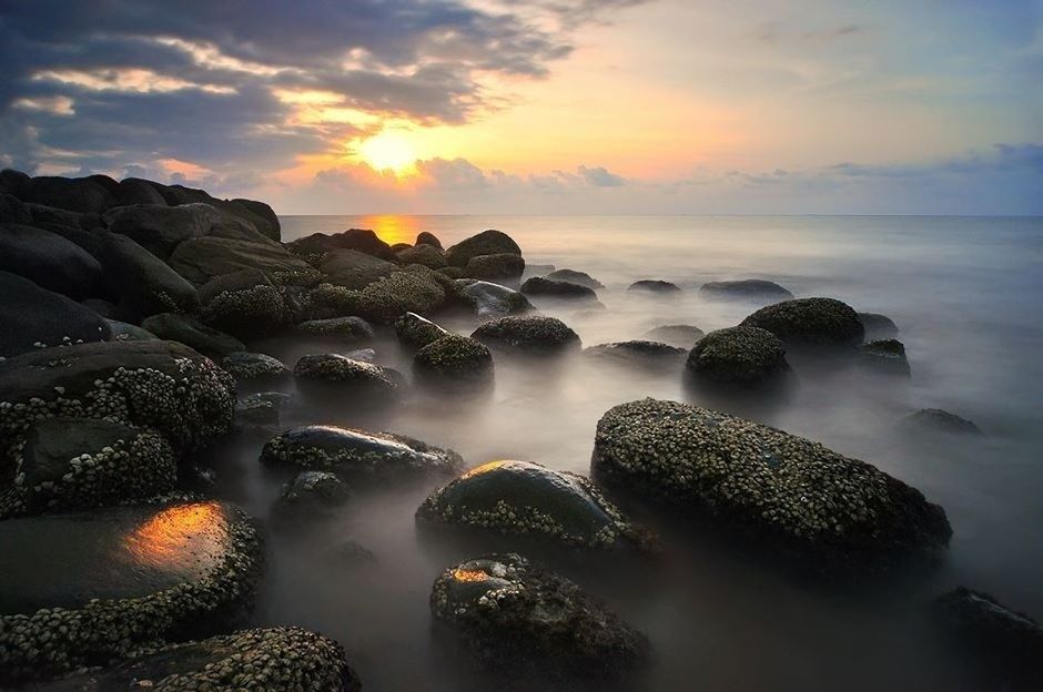 water, sunset, sea, scenics, rock - object, beauty in nature, tranquil scene, sky, tranquility, nature, horizon over water, idyllic, cloud - sky, beach, orange color, shore, reflection, sun, stone - object, rock formation