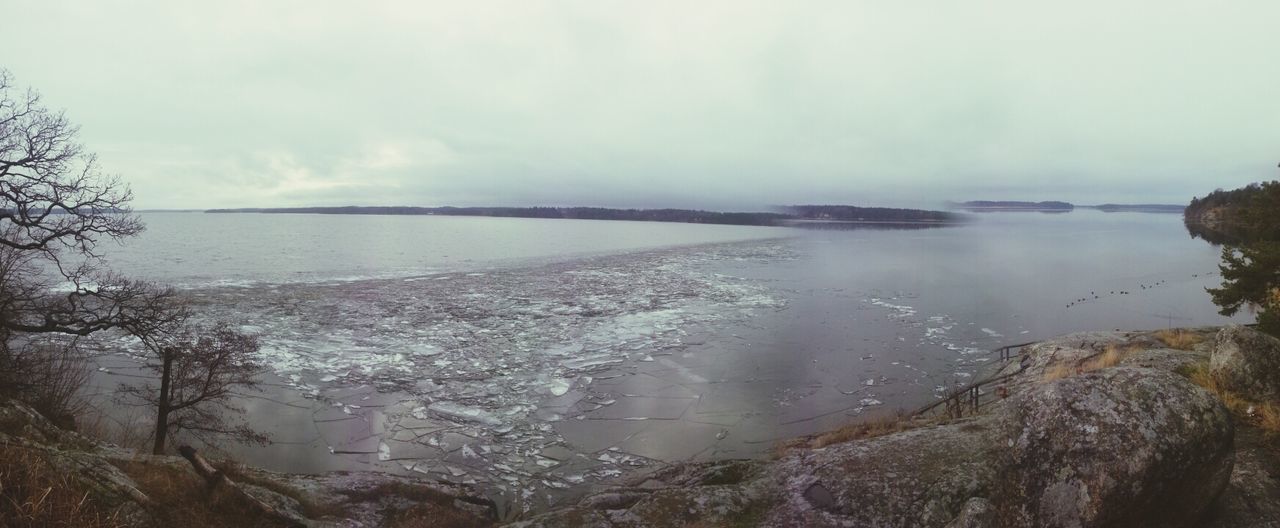 water, sky, tranquil scene, tranquility, scenics, sea, beauty in nature, nature, cloud - sky, shore, beach, idyllic, high angle view, horizon over water, lake, weather, outdoors, day, no people, cloudy