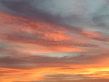 Low angle view of cloudy sky at sunset