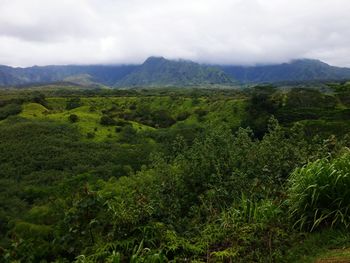 Scenic view of mountains against cloudy sky