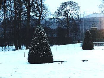 Snow covered cemetery against sky